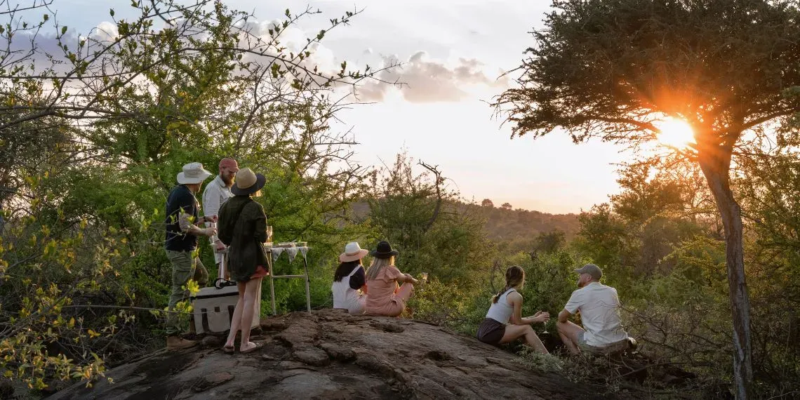 mensen zitten op een rots naar de omgeving